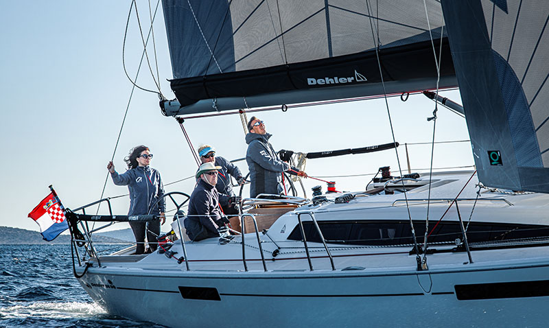 Sailing crew enjoys nice day sailing in the Adriatic seaduring RYA course.
